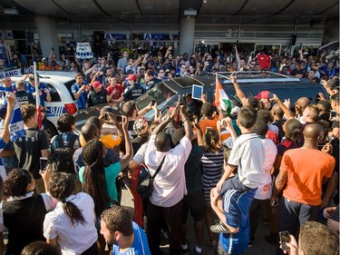 Fans of Didier Drogba surround his car as police try to hold clear a path at Pierre Trudeau Airport in Montreal on July 29, 2015.