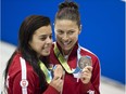 Silver medalist Roseline Filion (R) of Canada and bronze medalist Meghan Benfeito (L) of Canada pose following the Womens 10m Platform finals at the 2015 Pan American Games in Toronto, Canada, July 11, 2015.