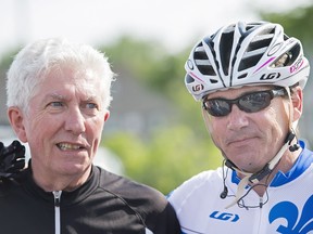 Bloc Quebecois Leader Gilles Duceppe, left, talks with Parti Quebecois leader Pierre Karl Peladeau prior to setting off on their bicycles in Repentigny on July 29, 2015, for a tour of some regions of Quebec.