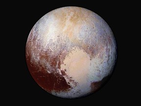 This image made available by NASA on Friday, July 24, 2015, shows a combination of images captured by the New Horizons spacecraft with enhanced colours to show differences in the composition and texture of Pluto's surface. The images were taken when the spacecraft was 450,000 kilometres away.