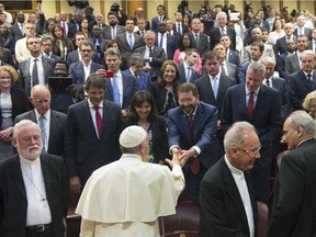 Pope Francis greets Rome Mayor Ignazio Marino as he meets mayors gathered in the Synod Hall during a conference on Modern Slavery and Climate Change at the Vatican, Tuesday, July 21, 2015. Dozens of environmentally friendly mayors from around the world are meeting at the Vatican this week to bask in the star power of eco-Pope Francis and commit to reducing global warming and helping the urban poor deal with its effects. Next to Marino, at left, is Paris Mayor Anne Hidalgo, at his right is New York Mayor Bill de Blasio and between the two, one row back is Boston Mayor Marty Walsh.