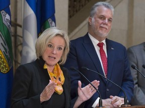 Alberta Premier Rachel Notley responds to reporters questions as Quebec Premier Philippe Couillard, right, looks on, Tuesday, July 14, 2015 at a news conference following a meeting in Quebec City.