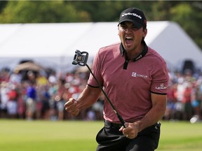 Jason Day of Australia celebrates after putting for birdie on the 18th green to win during the final round of the RBC Canadian Open at Glen Abbey Golf Club on July 26, 2015 in Oakville, Canada.