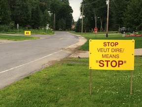 Residents of Cambridge St. in Hudson have posted signs to encourage drivers to slow down and obey the stop signs near the spot where 21-year-old Tina Lyon-Adams was hit by a car on June 12, 2015. Montreal Gazette photo.