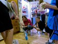 A mother cleans up a broken glass that was dropped after dinner with her family. Women are more stressed than ever when it comes to finding work-life balance.