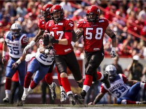 Calgary Stampeders' Simon Charbonneau-Campeau, centre, runs the ball during second half CFL football action against the Montreal Alouettes in Calgary on Saturday, June 28, 2014. The Alouettes lost the game 29-8.