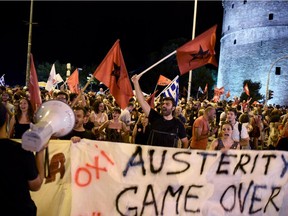 Supporters of the No vote celebrate after the results of the referendum in the northern Greek port city of Thessaloniki, Sunday, July 5, 2015. Greeks overwhelmingly rejected creditors' demands for more austerity in return for rescue loans in a critical referendum Sunday, backing Prime Minister Alexis Tsipras, who insisted the vote would give him a stronger hand to reach a better deal.