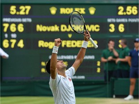 Serbia's Novak Djokovic celebrates beating Switzerland's Roger Federer during their men's singles final match on Centre Court on day thirteen of the 2015 Wimbledon Championships at The All England Tennis Club in Wimbledon, southwest London, on July 12, 2015.  Djokovic won the match 7-6, 6-7, 6-4, 6-3.