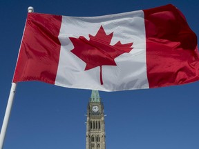 The Canadian Flag flies over the Peace Tower on Parliament Hill on the 50th anniversary of the Canadian Flag in Ottawa on Sunday, Feb. 15, 2015.