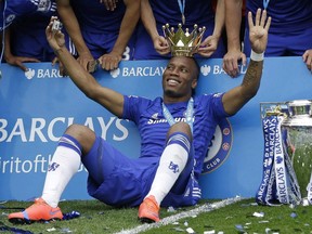 The crown of the trophy is placed on the head of Didier Drogba after the English Premier League soccer match between Chelsea and Sunderland at Stamford Bridge stadium in London, Sunday May 24, 2015.The Montreal Impact are keeping quiet while their fans eagerly await news on perhaps the biggest signing in club history - former Chelsea striker Drogba.