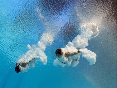TOPSHOTS PICTURE TAKEN WITH AN UNDERWATER CAMERA - Canada's divers Maeghan Benfeito and Roseline Filion compete in the Women's 10m platform synchronised preliminaries diving event at the 2015 FINA World Championships in Kazan on July 27, 2015.