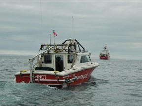 UNDATED -- The Canadian Hydrographic Service survey boat Gannet, used as part of  the  search  for the lost Franklin vessels by Parks Canada's Underwater Archaeology  Service,  on its way back to the Canadian Coast Guard Ship Sir Wilfrid Laurier.