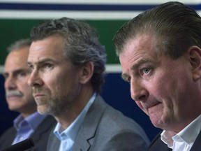 Vancouver Canucks general manager Jim Benning, right to left, President of Hockey Operations Trevor Linden and Head Coach Willie Desjardins attend a news conference at Rogers Arena in Vancouver on April 29, 2015. The Vancouver Canucks cleaned out their front office, firing assistant general managers Laurence Gilman and Lorne Henning and director of player personnel Eric Crawford. Canucks president Trevor Linden announced the three were relieved from their duties "after a thorough review of the team."