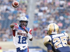 Montreal Alouettes quarterback Rakeem Cato (12) throws against Bruce Johnson (25) and the Winnipeg Blue Bombers during the first half of CFL action in Winnipeg Friday, July 10, 2015.
