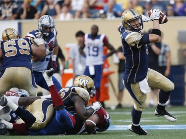 Winnipeg Blue Bombers quarterback Drew Willy (5) runs for yards against the Montreal Alouettes during the second half CFL action in Winnipeg Friday, July 10, 2015.