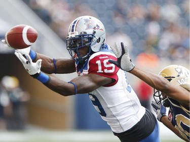 Alouettes' S.J. Green fails to hang onto pass during first half of CFL action against Johnny Adams and the Winnipeg Blue Bombers in Winnipeg Friday, July 10, 2015.