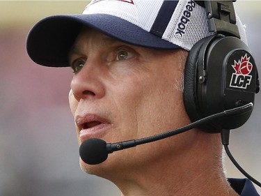 Montreal Alouettes head coach Tom Higgins looks up at the scoreboard during the first half of CFL action against the Winnipeg Blue Bombers in Winnipeg Friday, July 10, 2015.