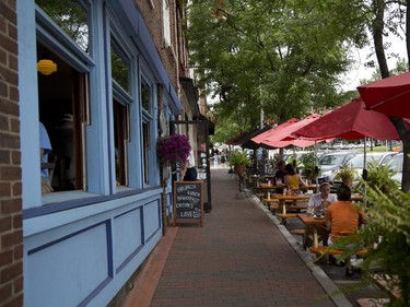 Main St. in Winooski, Vt. On a sunny Wednesday afternoon, the street is lively with people lingering over lunch at a row of sidewalk terrasses that hug the roundabout that coils through town.