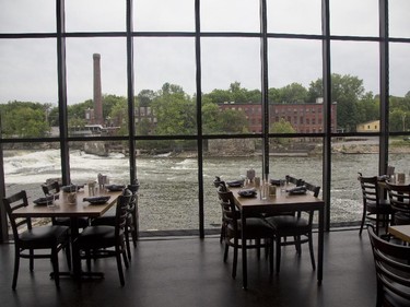 The Winooski River and Falls can be seen through the windows of  Waterworks Restaurant in Winooski, Vermont, Saturday June 27, 2015.
