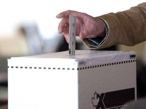 A voter casts a ballot in the 2011 federal election in Toronto on May 2, 2011.