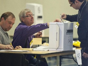 A voter casts his ballot in Canada's federal election at a polling station on May 2, 2011.