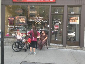 A woman in a wheelchair eats ice cream outside the Pâtisserie Polonaise during the summer of 2014. The shop was given a fine of $250 for "illegal furniture occupying the public domain" after the store set up a table outside for her. (courtesy of Janine Lauster)