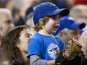 A young fan cheers as the Toronto Blue Jays get ready to play against the New York Yankees.