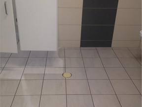 A taped-over drain in the men's bathroom of the new Montreal Children's Hospital in August 2015. The bathroom is one of several locations at the Children's where sewer water has backed up.