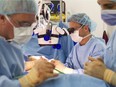 A plastic surgeon performs breast reconstruction surgery.