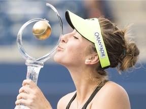 Belinda Bencic, of Switzerland, poses with winner's trophy after defeating Simona Halep, of Romania, in the women's final at the Rogers Cup tennis tournament in Toronto on Sunday, August 16, 2015.