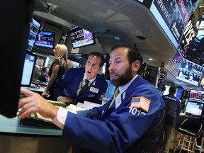 Traders work on the floor of the New York Stock Exchange (NYSE) in this file photo.