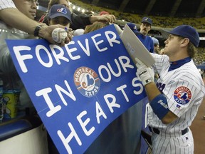 In this Sept. 29, 2004, file photo, Expos first- baseman Brad Wilkerson signs autographs before the team's final game at Montreal's Olympic Stadium against the Florida Marlins.