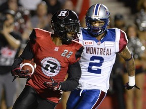 Ottawa Redblacks' Brandon McDonald (22) is chased by Montreal Alouettes' Fred Stamps (2) after making an interception during the second half of a CFL game in Ottawa on Friday, Aug. 7, 2015. The Redbacks won 26-23.