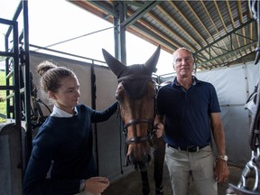 BROMONT, QC.: AUGUST 4, 2015 -- Lucy Deslauriers (left) and Mario Deslauriers (right) take care of one of their horses  at the Bromont Equestrian Olympic Park in Bromont, Quebec, on Wednesday, August 4, 2015.(Giovanni Capriotti / MONTREAL GAZETTE)