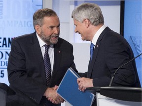 NDP leader Thomas Mulcair (L) shakes hands with Conservative leader Stephen Harper following the first leaders debate Thursday, August 6, 2015 in Toronto. It's a picture you'll surely see again between now and voting day, but not at a debate about women's issues.