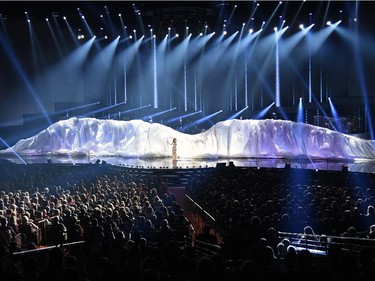 Singer Céline Dion (C) performs at The Colosseum at Caesars Palace as she resumes her residency on August 27, 2015 in Las Vegas, Nevada. The show had been on hiatus since August 2014 when Dion stopped performing to care for her ailing husband René Angélil.