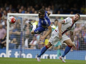 Chelsea's Gary Cahill, left, competes for the ball with Crystal Palace's Connor Wickham during the English Premier League soccer match between Chelsea and Crystal Palace at Stamford Bridge stadium in London, Saturday, Aug. 29, 2015.