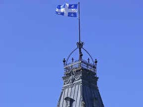 Clock tower on top of the National Assembly building. The colour and motif of Quebec's flag seem to be perceived as surefire draws for Quebec nationalists.