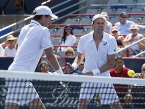 Daniel Nestor watches his doubles partner Édouard Roger-Vasselin, of France, return to Bob Bryan and Mike Bryan, of the United States, during the men's doubles final at the Rogers Cup tennis tournament Sunday August 16, 2015 in Montreal.