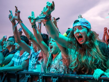 Music fans scream during the performance by Weezer on the second day of the 2015 edition of the Osheaga music festival at Jean-Drapeau park in Montreal on Saturday, August 1, 2015.