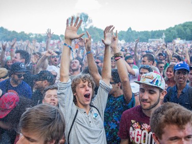 MONTREAL, QUE.: AUGUST 2, 2015 -- A music fan is sprayed with water during the performance by Gary Clark Jr. on the third day of the 2015 edition of the Osheaga music festival at Jean-Drapeau park in Montreal on Sunday, August 2, 2015.