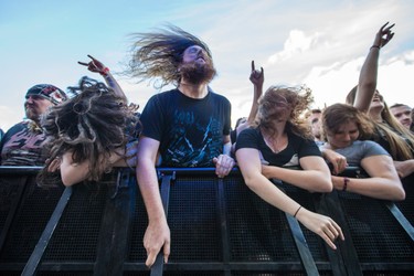 Music fans enjoy the performance by the French band Gojira on day two of the Heavy Montreal music festival at Jean-Drapeau park in Montreal on Saturday, August 8, 2015.