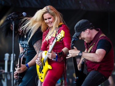 Lita Ford, centre, performs on day two of the Heavy Montreal music festival at Jean-Drapeau park in Montreal on Saturday, August 8, 2015.