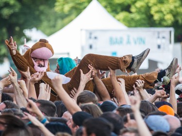 A music fan wearing a body costume body surfs during the performance by French band Gojira on day two of the Heavy Montreal music festival at Jean-Drapeau park in Montreal on Saturday, August 8, 2015.