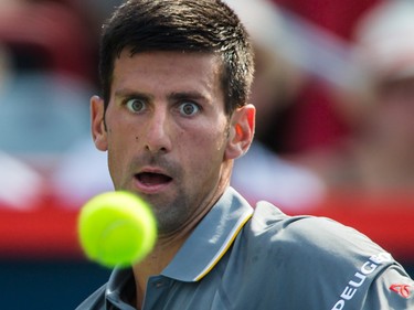 Novak Djokovic of Serbia keeps his eyes on the ball as he hits a return against Andy Murray of Great Britain during the men's final for the Rogers Cup Tennis Tournament at Uniprix Stadium in Montreal on Sunday, August 16, 2015.