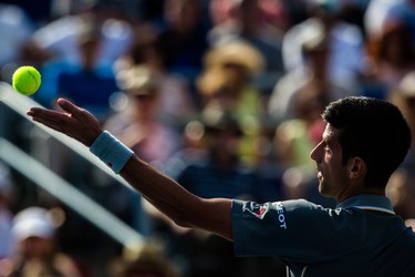Novak Djokovic of Serbia makes a serve against Andy Murray of Great Britain during the men's final for the Rogers Cup Tennis Tournament at Uniprix Stadium in Montreal on Sunday, August 16, 2015.