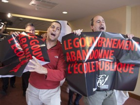 Demonstrators from a teacher's union interrupt at the beginning of a Quebec Liberal government caucus meeting, Thursday, August 27, 2015 in Saint-Georges-de-Beauce.