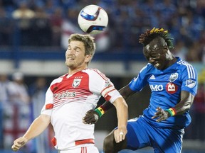 Montreal Impact's Dominic Oduro, right, challenges D.C. United's Bobby Boswell during first half MLS soccer action in Montreal, Saturday, August 8, 2015.