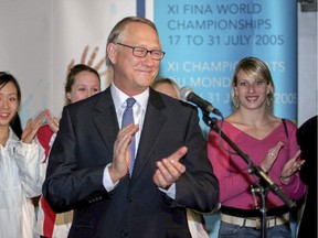 Montreal mayor Gérald Tremblay is applauded by members of the Canadian synchronized swim team (white and red jackets) and Olympic diver Emilie Heymans (right) on his arrival at Trudeau Airport Thursday evening after FINA returned the world aquatics championships to Montreal, on Feb. 10, 2005.