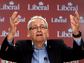 Liberal MP Marc Garneau holds a news conference to discuss the cost of Prime Minister Stephen Harper making an early election call, in Ottawa, Friday, July 31, 2015.